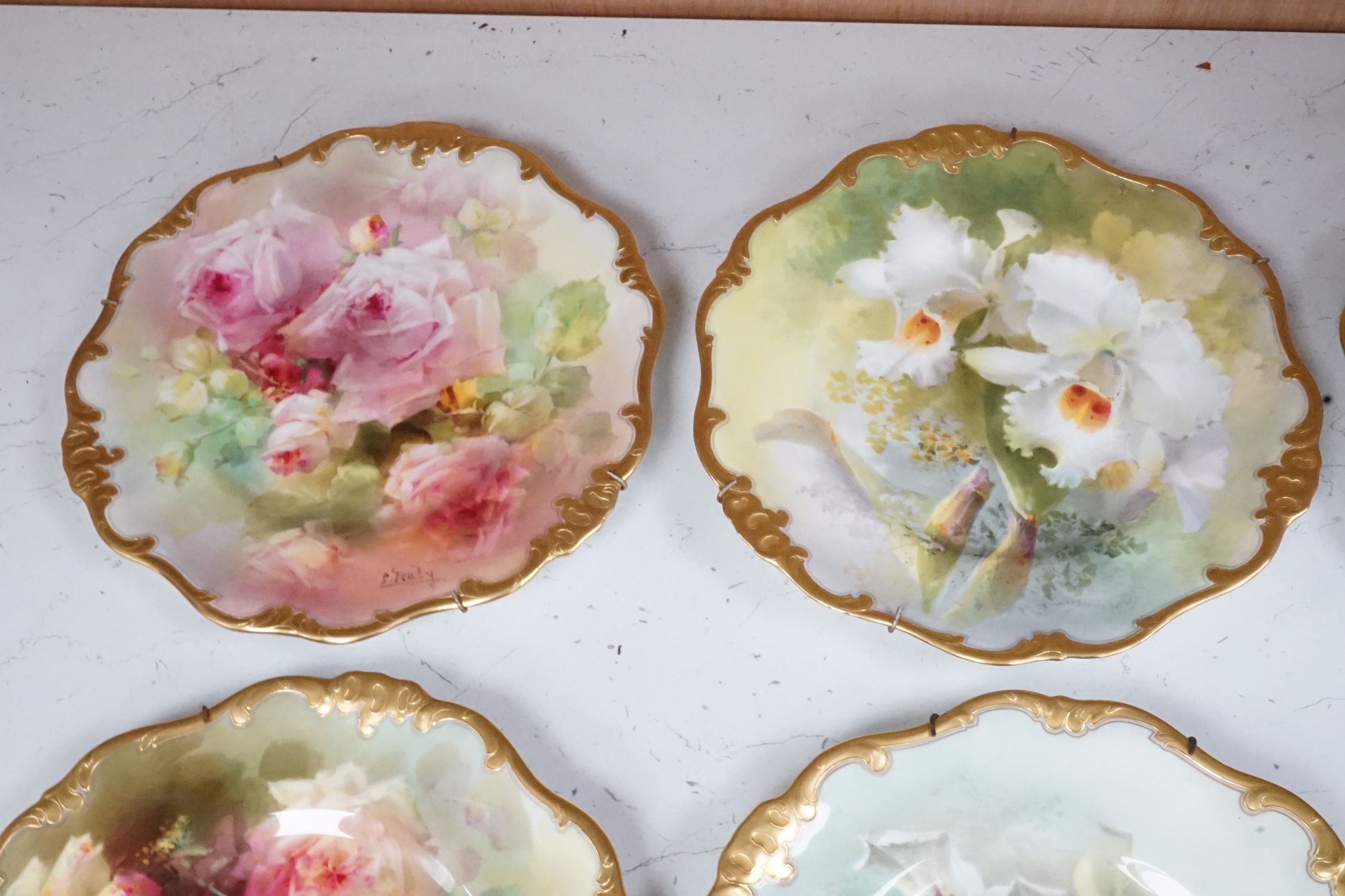 Six Royal Doulton floral painted plates, three signed E. Raby and three signed D. Dewsberry